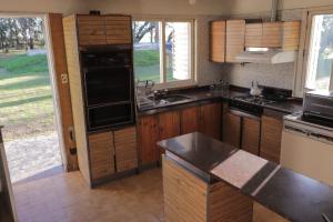 a kitchen with a sink and a stove top oven at Lo de Esther in Villa Constitución