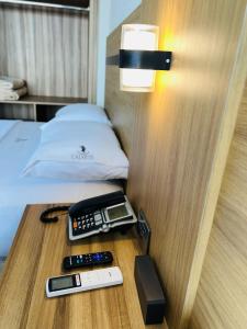 a room with a bed and a phone on a table at Hotel Calvete in Torreón +31 photos