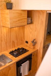 a kitchen with a stove and a sink at Whittle Home - NEW TINY HOME in Robe +12 photos