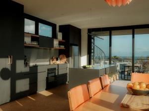 a kitchen and dining room with a table and chairs at Obliqua in Skenes Creek