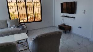 a living room with a couch and chairs and a table at Rest Sea Chaliet & Farm in Edh Dhrā‘