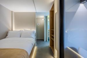 a bedroom with a white bed and a closet at NOK Luxury 3BR in Bogota with Terrace in street 84 in Bogotá