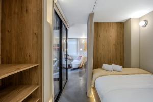 a small bedroom with a bed and a sliding glass door at NOK Luxury 3BR in Bogota with Terrace in street 84 in Bogotá