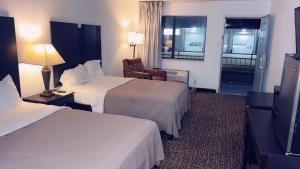 Ένα ή περισσότερα κρεβάτια σε δωμάτιο στο America's Best Value Inn