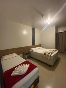 una habitación con dos camas en una habitación en Pousada Estrela Dalva, en Penha