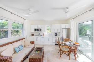 a living room with a couch and a table at Chuchubi Cottage in Long Bay Hills