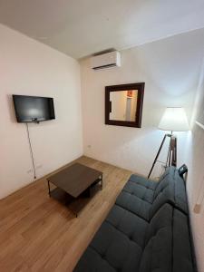 a living room with a couch and a flat screen tv at Departamento Privado en Los Cabos in San José del Cabo