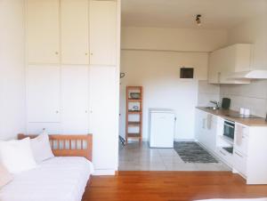 ein Wohnzimmer mit Sofa und eine Küche in der Unterkunft Brillarooms in Rethymno + 24 Fotos