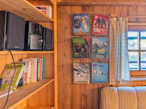 a wall with bookshelves and books in a room at Alte Grafenmühle in Hopfgarten im Brixental