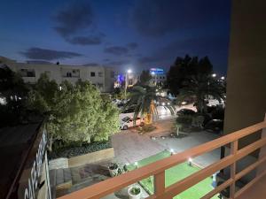a view of a park at night from a balcony at Coquette-Appart in Ez Zahra
