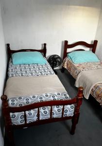 two beds sitting next to each other in a room at Casa Brisa do Mar in Tamandaré