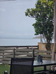 a table and chairs with a view of the ocean at Galazio suites 2 in Salamís