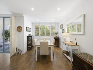 a dining room with a table and a desk at Bright 2-Bed Apartment Near Narrabeen Beach in Narrabeen