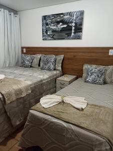 two beds sitting next to each other in a room at Pousada Maceio é Massa Pajuçara Frente ao Mar in Maceió