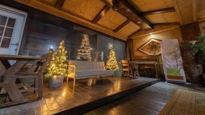 a living room with christmas trees and a couch at Taean Dokchae Trudy Pension in Taean