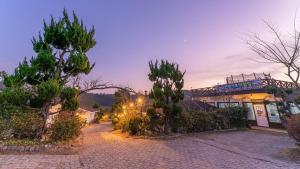 a cobblestone street in front of a building at Taean Dokchae Trudy Pension in Taean