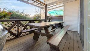 a wooden deck with a picnic table and an umbrella at Taean Dokchae Trudy Pension in Taean +12 photos