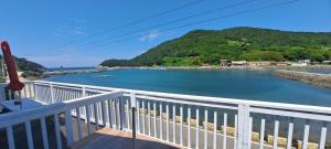 a view of a river from a balcony at Yeosu Geumodo Badaae Pension in Yeosu