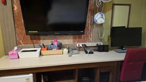 a desk with a flat screen tv on top of it at Sky Motel in Gumi