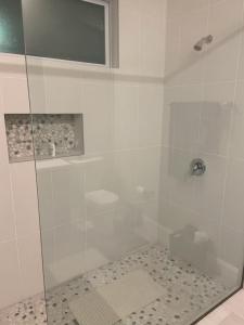 a bathroom with a shower with a glass door at Orlando 4 bedroom built in 2021 in Orlando +30 photos