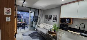 a living room with a couch and a table at Apartamento São Paulo Tatuapé in Sao Paulo
