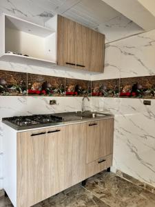 a kitchen with wooden cabinets and a stove top oven at El guadual apartahotel in Salento