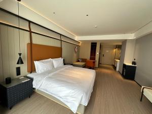 a hotel room with a large bed in a room at FunGeeX in Datong