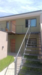 a house with stairs leading up to a balcony at Macarena in La Falda
