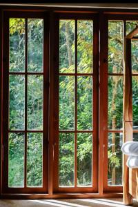 a window with four windows in a room at Mountain Villa & Nature Retreat - Fleur de Vie in Bedugul