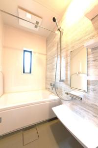 a bathroom with a tub and a sink and a mirror at Trailer Ship Garden Aso - Vacation STAY 09118v in Aso +17 photos