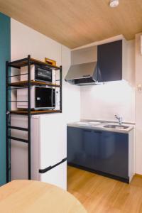 a kitchen with a refrigerator and a sink at Trailer Ship Garden Aso - Vacation STAY 09118v in Aso