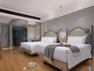 a hotel room with two beds and a table at Meisu Huanzhi Hotel Changsha Wuyi Square Hunan Museum Branch in Changsha