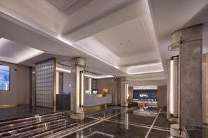 a lobby of a hotel with a staircase and a building at Meisu Huanzhi Hotel Changsha Wuyi Square Hunan Museum Branch in Changsha