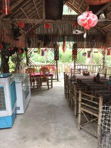 a restaurant with tables and chairs and red lanterns at Homestay gió lặng in Lũng Tiềm