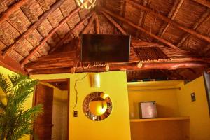 a room with a mirror and a laptop on the ceiling at Hotel Aldea Cruzo'ob in Felipe Carrillo Puerto