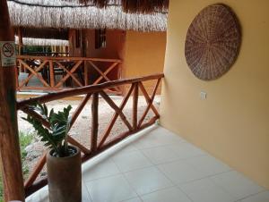 a room with a balcony with a potted plant at Hotel Aldea Cruzo'ob in Felipe Carrillo Puerto