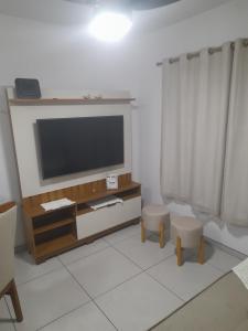 un salon avec une télévision à écran plat sur un mur dans l'établissement Apartamento Premium Torres-Rs, à Torres