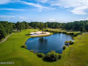 an overhead view of a golf course with a pond at Royal Pines in New Bern