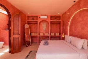 ein Schlafzimmer mit einem Bett und ein Badezimmer mit einer Badewanne in der Unterkunft Villa Solea in Gili Trawangan