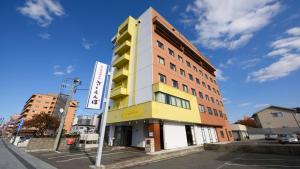 a building on the corner of a street at Hotel Sakuranbo in Yamagata