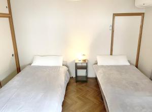 Ένα ή περισσότερα κρεβάτια σε δωμάτιο στο Izu-Nagaoka The NooK Guest House