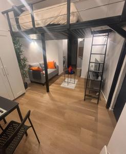 a living room with a loft bed and a couch at Le basque in Douai