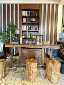 a wooden table in a room with logs at Yazhu Creekfront Boutique Hotel in Zhangjiajie