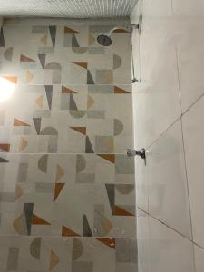 a shower with a glass door in a bathroom at Mini Kitnet-Caraíva- Nova caraiva in Caraíva +6 photos