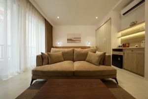 a living room with a couch in a room at Lens Stay in Ho Chi Minh City