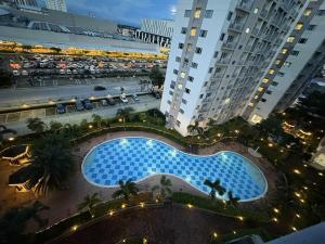 an overhead view of a large blue pool in a city at Cozy Sunset Condo Thompson Stay in Manila