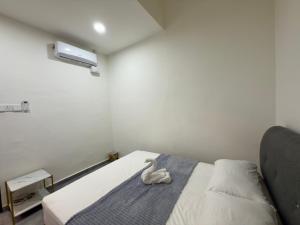 a room with a bed with a stuffed animal on it at Vs Homestay Semambu Kuantan in Kuantan