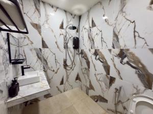 a bathroom with a shower and a sink at Vs Homestay Semambu Kuantan in Kuantan +3 photos