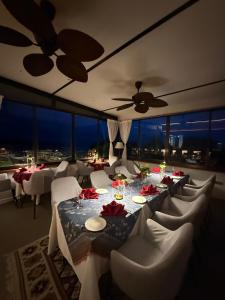 a dining room with tables and chairs and a ceiling fan at Ambong Pool Villas - Private Pool in Pantai Cenang +242 photos