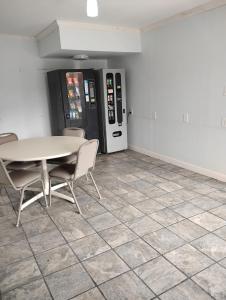 a dining room with a table and a soda machine at Gated 2 Double Bed Studio with Full Kitchen 116 in Baton Rouge +15 photos